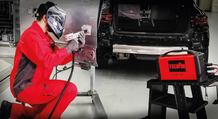 Welder using TSM-supplied equipment on an automotive body